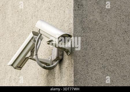 Two CCTV cameras on grey concrete wall. CCTV security system Stock Photo