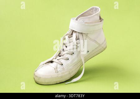 White leather shoe on the green background Stock Photo