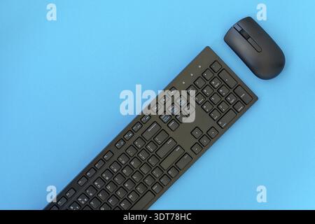 Wireless computer keyboard and mouse on the blue background Stock Photo
