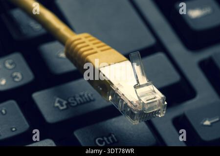 Yellow internet switch, close up macro shot on computer keyboard Stock Photo
