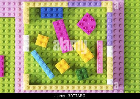 Toys background with colorful plastic building blocks. Top view Stock Photo