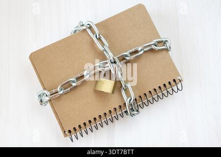 Censorship concept, notepad with chain and padlock Stock Photo