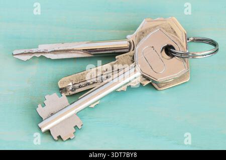 Bunch of different keys on wooden table Stock Photo