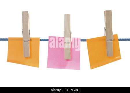 Color paper sheets on rope. isolated over a white background Stock Photo