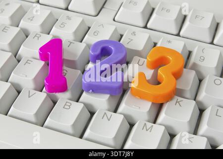Three color plastic numbers on the computer keyboard Stock Photo