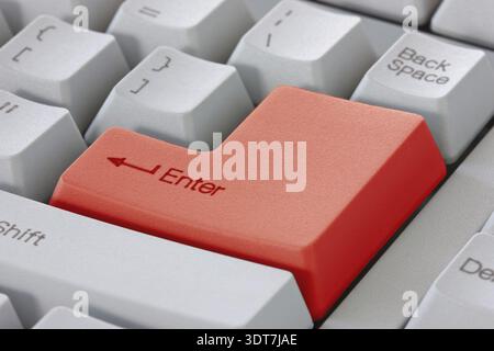 Red enter button on the computer keyboard Stock Photo