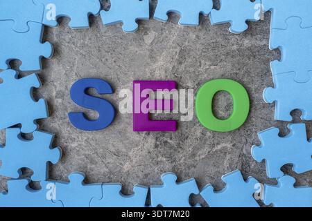 SEO, Search Engine Optimization ranking concept.Alphabets abbreviation SEO in a middle of jigsaw puzzle frame Stock Photo
