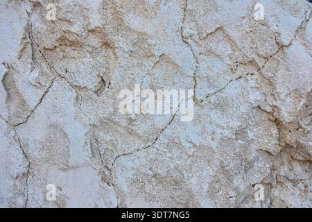 Light beige plaster wall texture with natural cracks and weathered surface. Inspired by Arabic and Middle Eastern architecture. Stock Photo