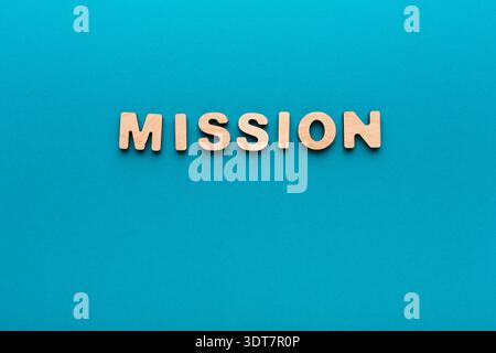Wooden Letters Spell out Mission on a Blue Background in a Simple Arrangement Stock Photo