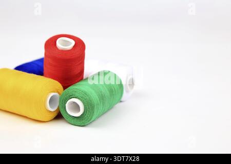 Colourful spools of thread lie on a white background Stock Photo