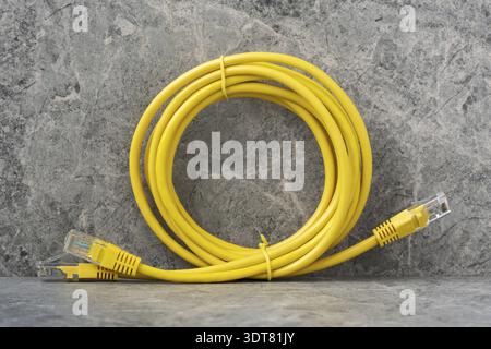 LAN network connection ethernet cables. Internet cables RJ45 on the stone background Stock Photo