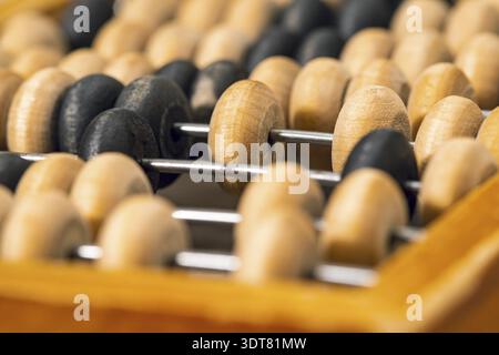 Close-up photo of vintage wooden abacus for calculation. Selective focus Stock Photo