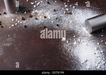 Salt and Pepper Shakers Spill Contents on the Table During Cooking Session Stock Photo