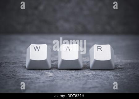 Computer keyboard keys arranged to spell WAR word. Cyberwar concept Stock Photo
