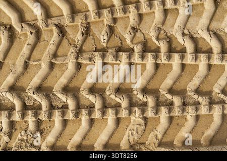 Tyre tracks on brown sand in construction site. Abstract background and pattern Stock Photo