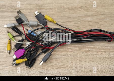 Bundle of various cables with various connectors suitable for different ports. Concept of great number of pc peripherals, equipments and connected dev Stock Photo