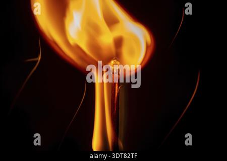 Ignition of a match, with smoke on dark background. A beauty of burning match, isolated in black background. Fire styling Stock Photo