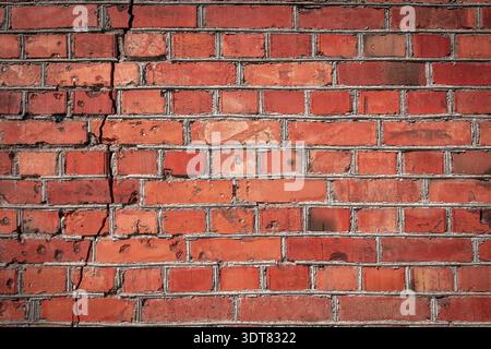 The crack in the brick wall. Red Brick wall background Stock Photo