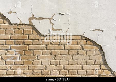 Plastered Brickwall With Chipped Stucco Pieces. White Brick Wall With Damage Surface. Old Grunge Abstract Background Stock Photo