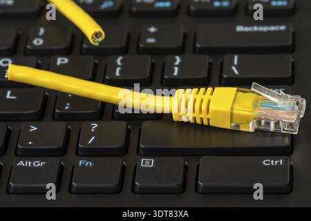 Internet connection disconnected, yellow network cable cutted off Stock Photo