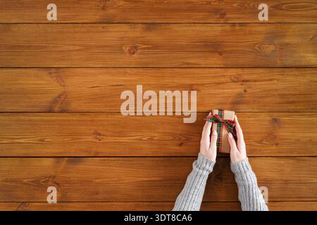 Collection of Gift Boxes on Wooden Table in Warm Light During Holiday Season Preparations Stock Photo