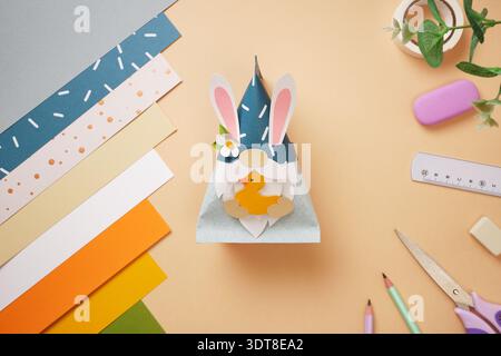 Paper craft. Gnome with rabbit ears and duck in his hands. DIY handmade project for children. Stock Photo