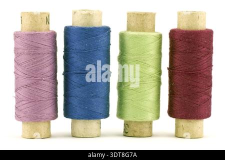 Four colorful thread spools, isolated on white background Stock Photo