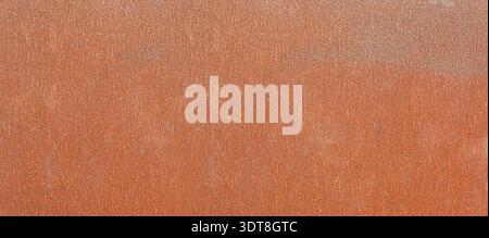Rusty metal surface showing weathered oxidation, creating a textured industrial background Stock Photo