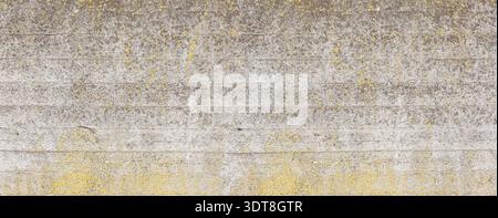 Rough concrete wall showing textured surface and natural aging with yellow mold Stock Photo