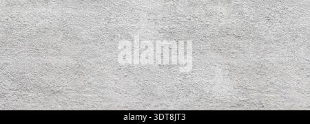 Rough white stucco wall surface creating a grainy exterior texture Stock Photo