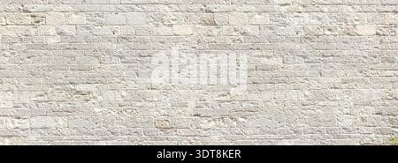 Grey stone wall showing ancient texture and masonry blocks Stock Photo