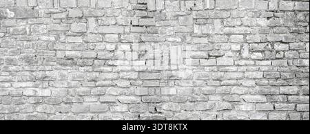 Weathered gray brick wall presenting a rustic old architectural background Stock Photo