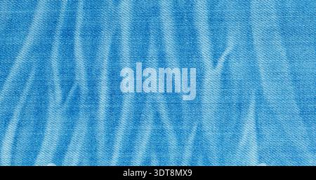 Faded blue denim fabric showing textile texture with light and dark patterns Stock Photo