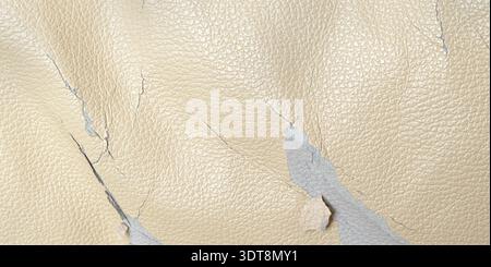 Beige synthetic leather upholstery showing cracks and wear Stock Photo