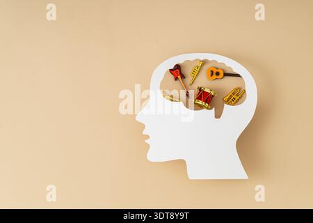 Music in the human brain. Creativity, memory and cognitive development concept. Trendy beige, neutral color background. Flat lay style. Top view. Stock Photo