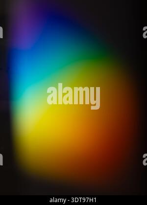 Abstract composition with a smooth gradient of spectral colours flowing across a dark background, creating a vibrant and modern visual effect. Stock Photo