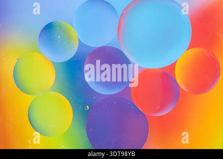 Oil drops in water and air bubbles, macro photo, selective focus. Bright multicolored rainbow background Stock Photo