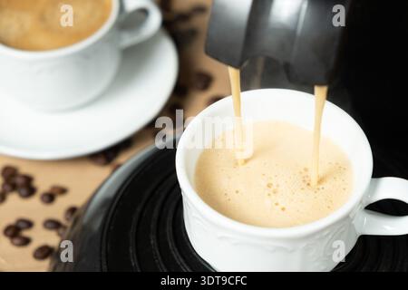 Process of making coffee using a pod machine with two streams of beverage Stock Photo