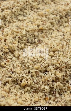 Detailed texture background of ground walnut kernels. Stock Photo