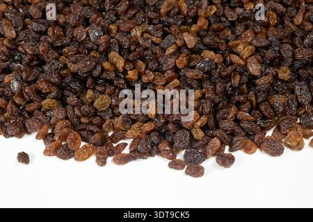 Pile of brown raisins isolated on white background Stock Photo