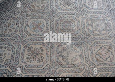 Close-up of an ancient Roman mosaic with octagonal medallions and braided borders at the Villa Romana de Carranque, Toledo, Spain. Stock Photo