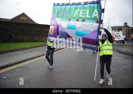 ALLOA, SCOTLAND – February 21st, 2026: Protesters seen holding banners during the march.  Protesters gather and march from Alloa Town Hall to Forth Valley College Alloa Campus during the "March for Alloa Campus" rally. The event, supported by EIS (Educational Institute of Scotland), GMB, and UNISON unions, opposes potential campus closure amid severe Scottish further education funding cuts and rising costs. Speakers included FVC Principal Kenny MacInnes, MSPs Keith Brown and Richard Leonard, MP Brian Leishman, and union representatives. Stock Photo