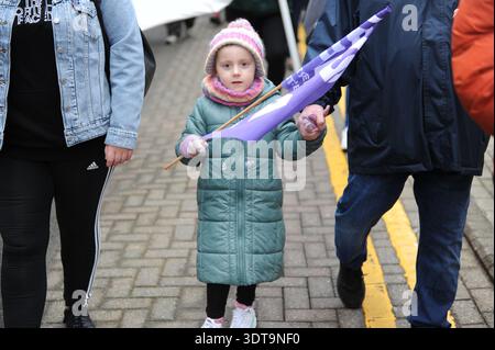ALLOA, SCOTLAND – February 21st, 2026: A small child is seen during the march with a EIS flag.  Protesters gather and march from Alloa Town Hall to Forth Valley College Alloa Campus during the "March for Alloa Campus" rally. The event, supported by EIS (Educational Institute of Scotland), GMB, and UNISON unions, opposes potential campus closure amid severe Scottish further education funding cuts and rising costs. Speakers included FVC Principal Kenny MacInnes, MSPs Keith Brown and Richard Leonard, MP Brian Leishman, and union representatives. Stock Photo