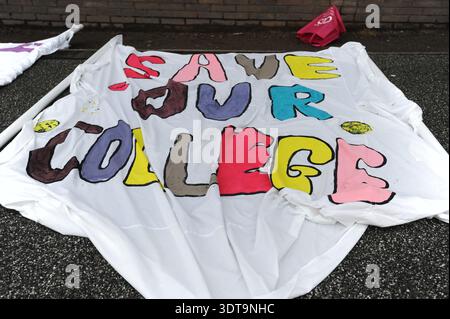 ALLOA, SCOTLAND – February 21st, 2026: Banner reading SAVE OUR COLLEGE is seen laid out.  Protesters gather and march from Alloa Town Hall to Forth Valley College Alloa Campus during the "March for Alloa Campus" rally. The event, supported by EIS (Educational Institute of Scotland), GMB, and UNISON unions, opposes potential campus closure amid severe Scottish further education funding cuts and rising costs. Speakers included FVC Principal Kenny MacInnes, MSPs Keith Brown and Richard Leonard, MP Brian Leishman, and union representatives. Stock Photo