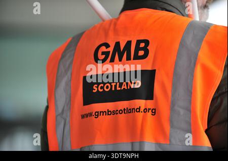 ALLOA, SCOTLAND – February 21st, 2026: GMB union rep is seen standing at the rally.  Protesters gather and march from Alloa Town Hall to Forth Valley College Alloa Campus during the "March for Alloa Campus" rally. The event, supported by EIS (Educational Institute of Scotland), GMB, and UNISON unions, opposes potential campus closure amid severe Scottish further education funding cuts and rising costs. Speakers included FVC Principal Kenny MacInnes, MSPs Keith Brown and Richard Leonard, MP Brian Leishman, and union representatives. Stock Photo