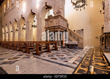 People explore the interior of the Cathedral of Syracuse in Ortygia Island, Sicily, observing its architecture and historic elements. Stock Photo