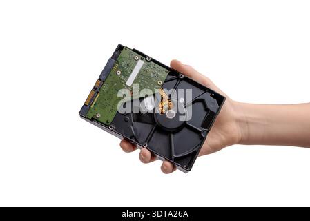 Hand holding opened hard disk drive showing internal platter and circuit board, computer storage component isolated on white background Stock Photo