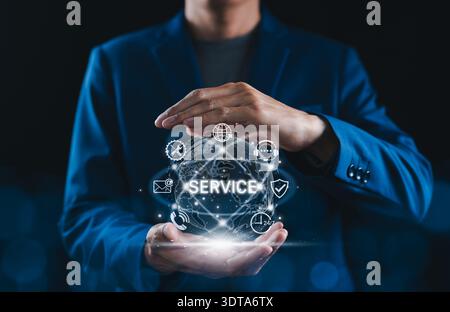 Customer service concept, businessman protecting digital globe with service icons representing global support, technical assistance, online communicat Stock Photo