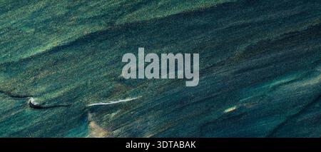 Abstract dark teal and green textured surface with diagonal brushstroke pattern Stock Photo