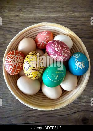 Easter eggs decorated with pysanky patterns in basket Stock Photo